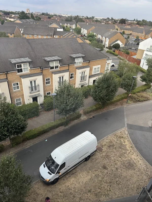 View over a residential neighbourhood with a white removal van below
